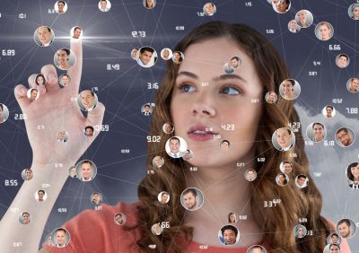 Woman touching digitally generated social networking icons against sky background